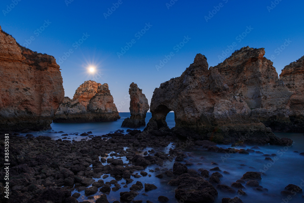 View of the beautiful rock formations at the Ponta da Piedade, near the city of Lagos, Algarve, at dusk; Concept for travel in Portugal