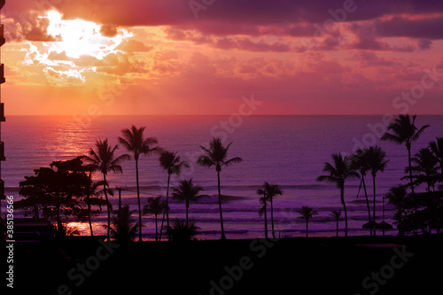 Breathtaking panorama of sunrise on the beach Ilh  us BA nascer do sol na praia do sul Ilh  us  with silver lining and cloud in orange sky and coconut trees on the coast