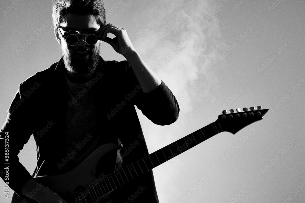 Male musician with guitar music rock star light background - obrazy, fototapety, plakaty 