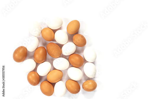 Many white and brown chicken eggs in a row isolated against a white background.