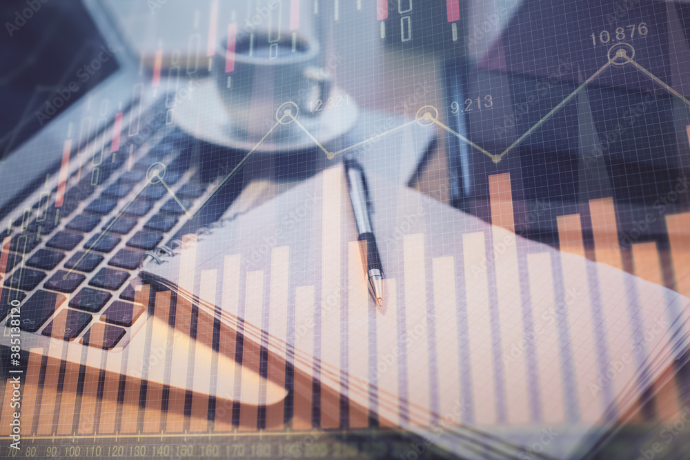Double exposure of forex chart drawing and desktop with coffee and items on table background. Concept of financial market trading Double exposure of forex chart drawing and desktop with coffee and items on table background. Concept of financial market trading