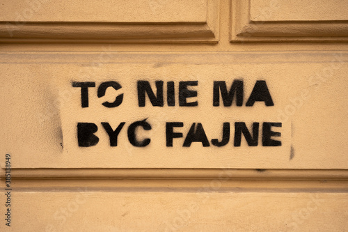 Fototapeta Naklejka Na Ścianę i Meble -  Sprayed stencil graffiti text on wall saying 