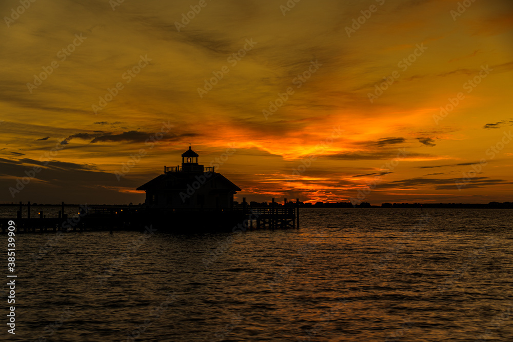 Lighthouse at Sunrise with Orange Sky