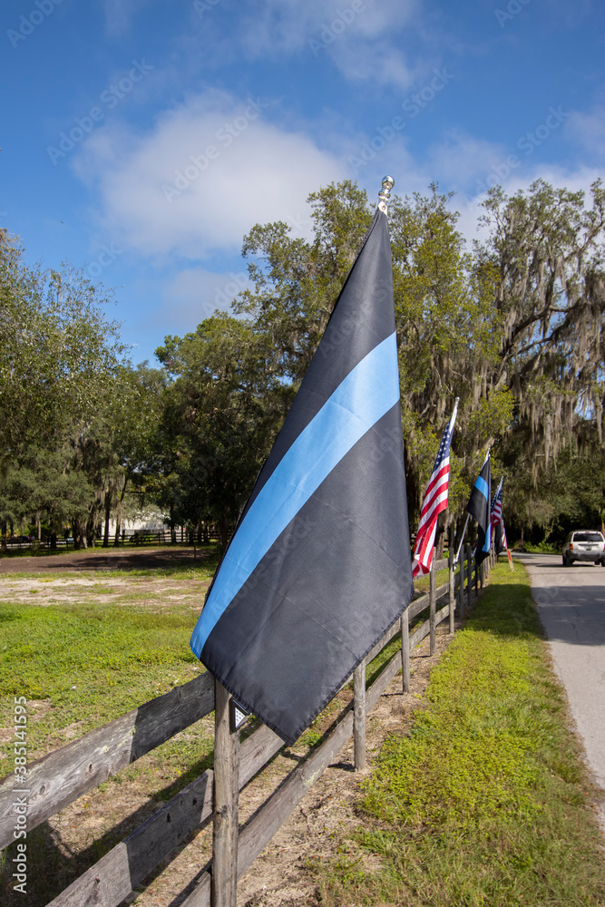 Blue Lives Matter flag aka Police Thin Blue Line flag, waving in the ...