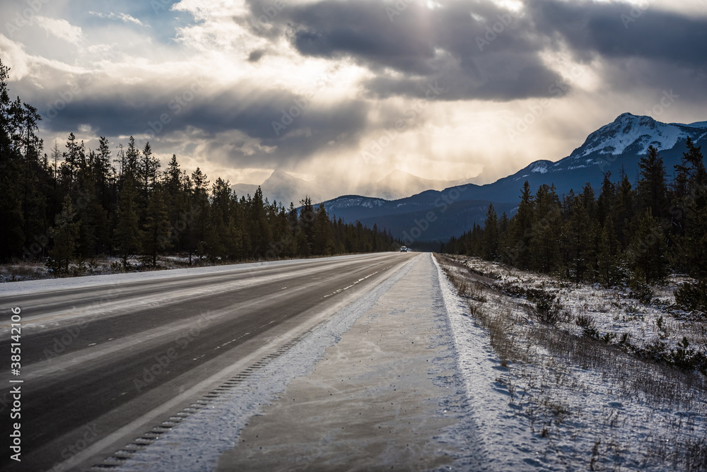Sunrays through cloudy skies seen from the Trans Canada Highway between Banff and Jasper. Alberta, Canada. Sunrays through cloudy skies seen from the Trans Canada Highway between Banff and Jasper. Alberta, Canada.