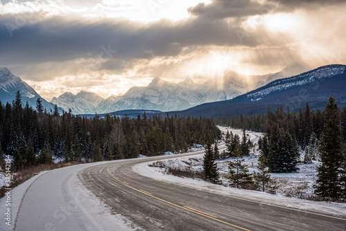 Sunrays through cloudy skies seen from the Trans Canada Highway between Banff and Jasper. Alberta, Canada.