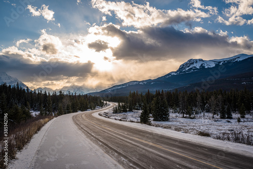 Sunrays through cloudy skies seen from the Trans Canada Highway between Banff and Jasper. Alberta, Canada.