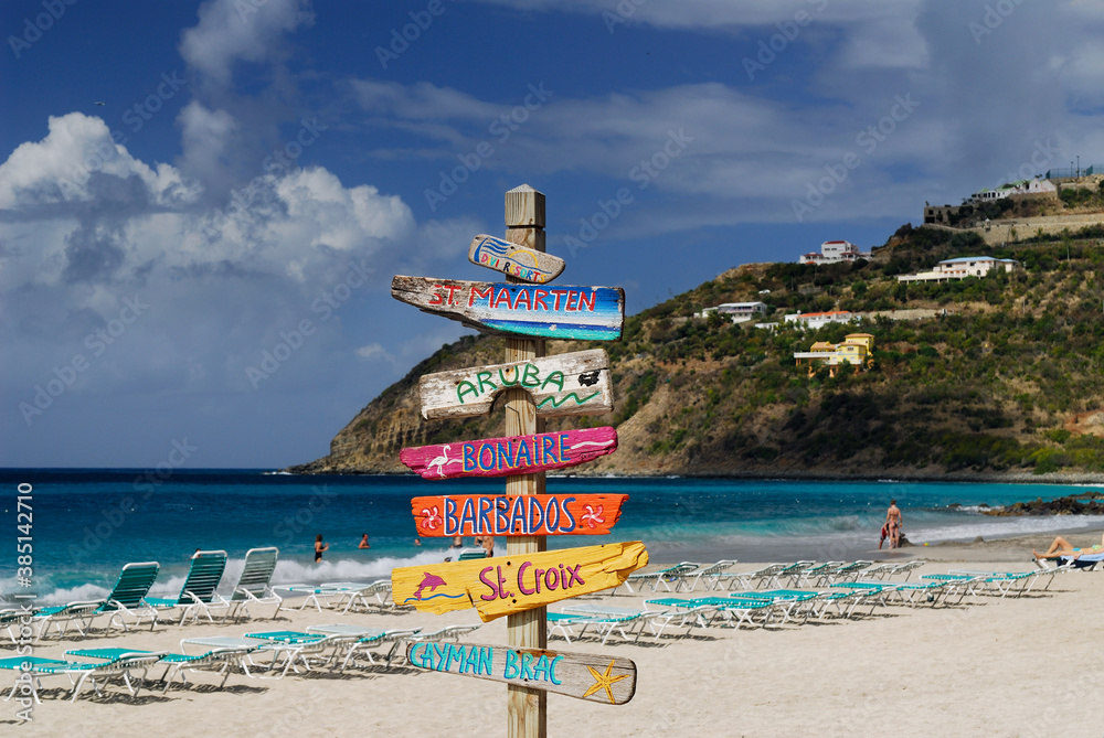 Signpost of Caribbean islands on the beach at St Maarten