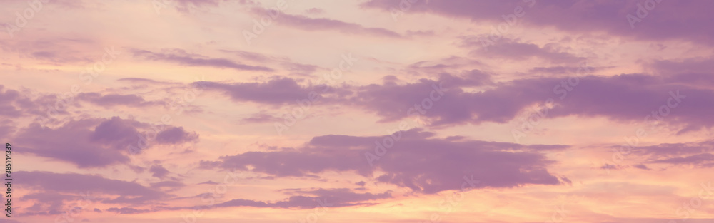 Beautiful colorful pink purple clouds on sky at sunset or sunrise. Evening or morning pastel color sky natural eco backgrounds. Amazing nature texture surface wallpaper. Web banner header.