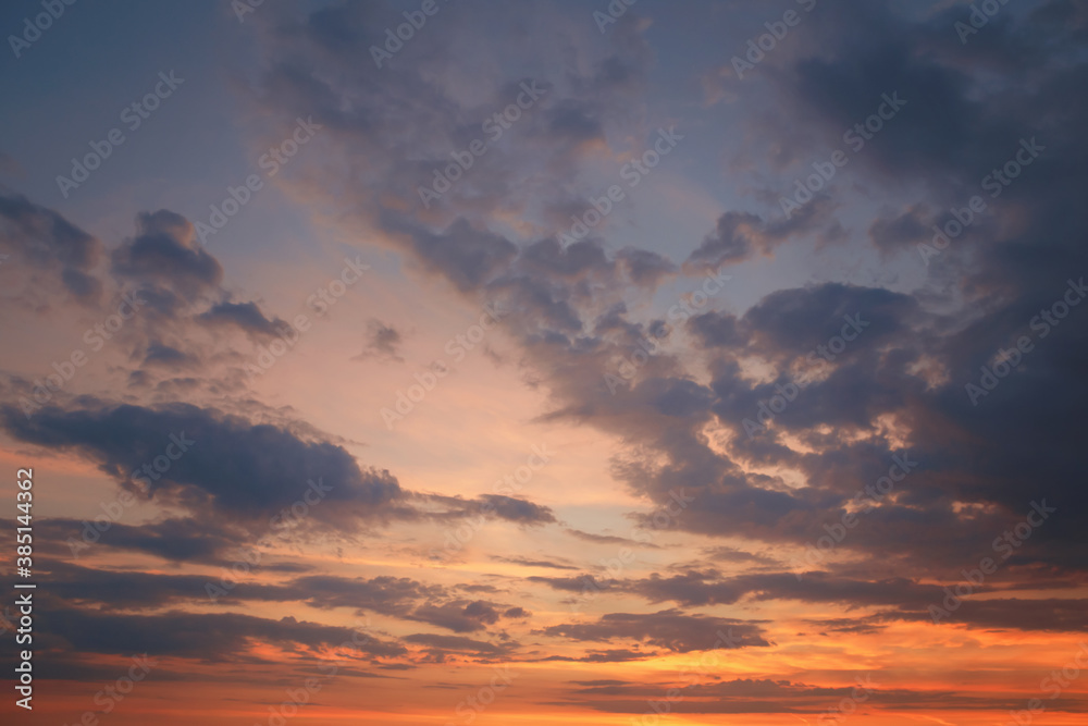 Beautiful bright colorful pink red yellow clouds on dark sky at sunset or sunrise. Evening morning dramatic sky background. Amazing nature texture surface wallpaper. Web banner header.