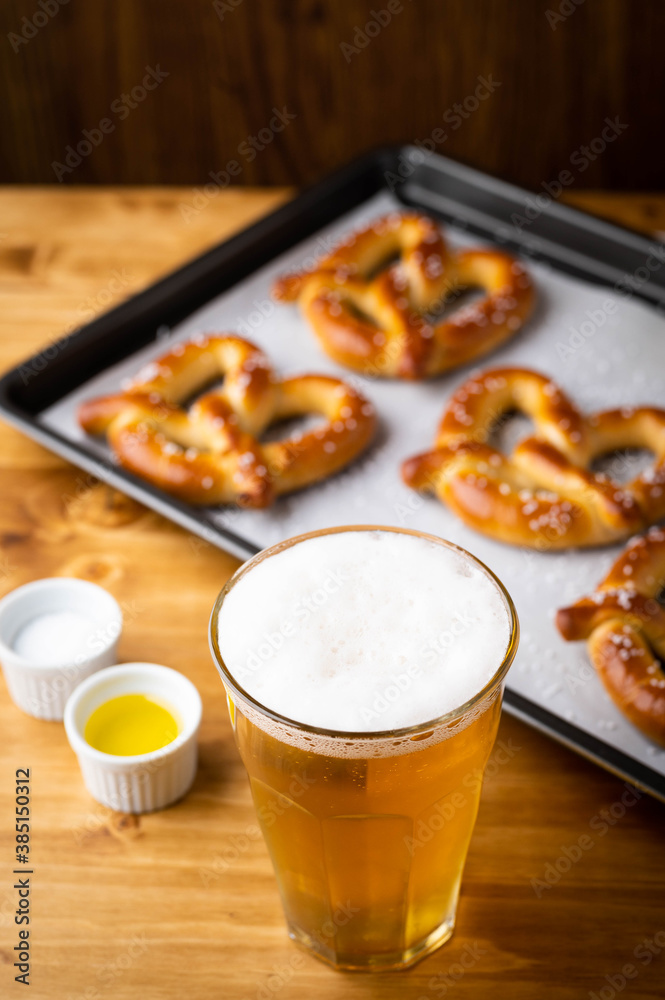 baked pretzel on cooking pan with beer baked pretzel on cooking pan with beer