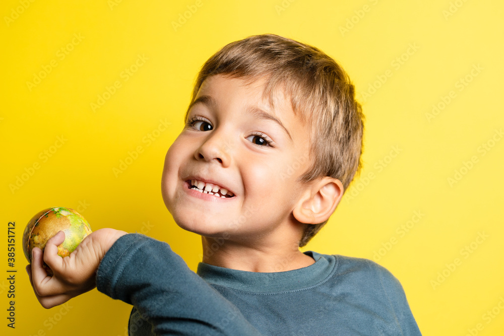 Portrait of happy joyful small caucasian boy in front of yellow background making faces - Childhood growing up and achievement concept - front view waist up copy space Portrait of happy joyful small caucasian boy in front of yellow background making faces - Childhood growing up and achievement concept - front view waist up copy space