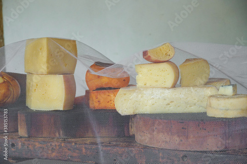 Variety of traditional cheese in a cheese farm store, dry aged cheeses