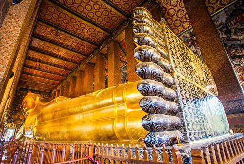 The Big Reclining Buddha statue in Wat Pho Temple, an Asian style Buddha Art, open to worship. Wat Pho is an important temple in Bangkok, Thailand. photo