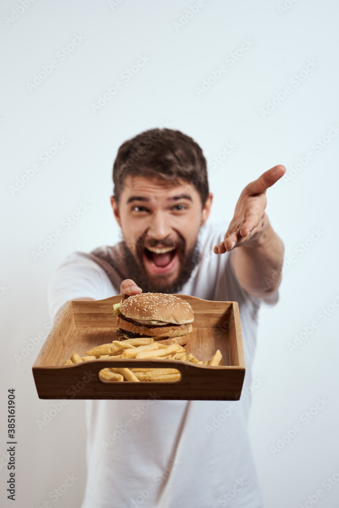 man with wooden tray fries and hamburger fast food calories model white t-shirt man with wooden tray fries and hamburger fast food calories model white t-shirt