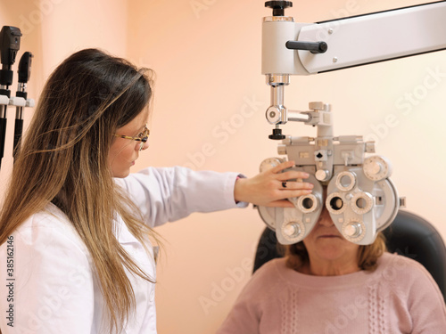 Young optometrist examining pacient