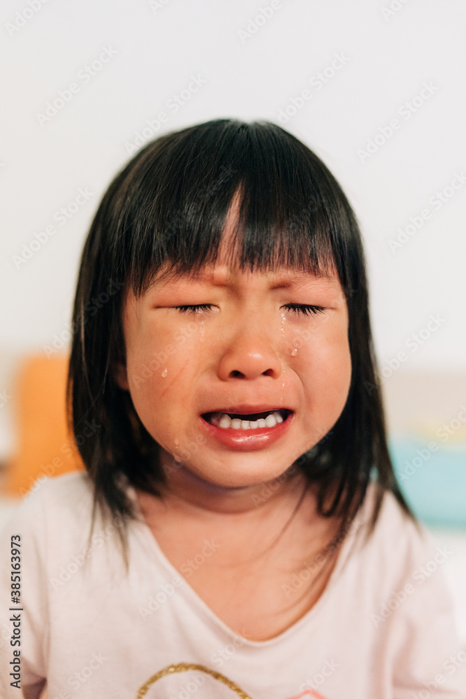 Asian little girl crying with tears in her face Asian little girl crying with tears in her face