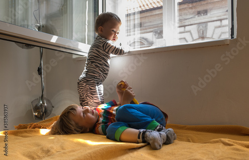 Two toddler brothers play at home