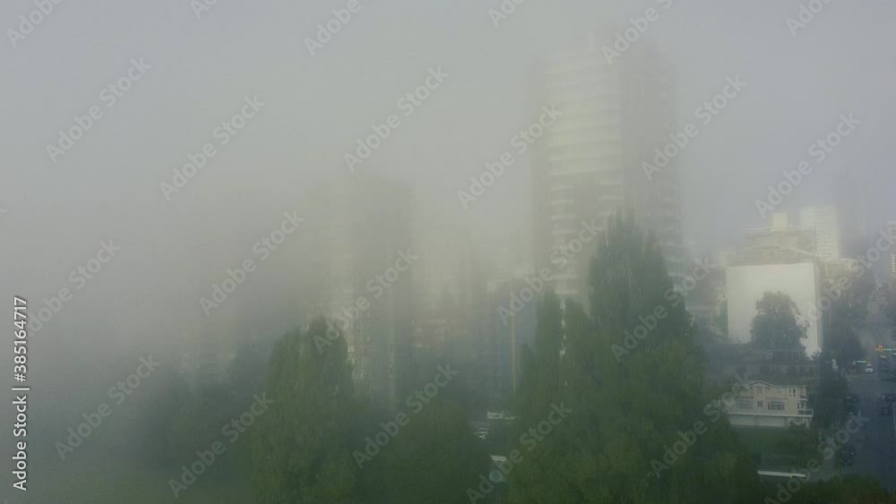 Drone shot of Vancouver downtown covered with the dense smoke on a sunny day
