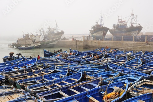 Small blue fishing boats and trawlers in the fishing port of Essaouira, Atlantic coast, Morocco, Africa photo