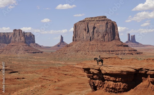 Viewpoint John Ford's Point, tourist on horseback, East Mitten Butte, West Mitten Butte, Merrick Butte, Castle Butte, Bear and Rabbit, Stagecoach, Mitchell Mesa table mountains, Monument Valley Navajo Tribal Park, Navajo Nation Reservation, Arizona, Utah, United States of America