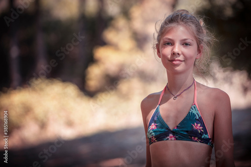 Girl smiling while standing at beach photo