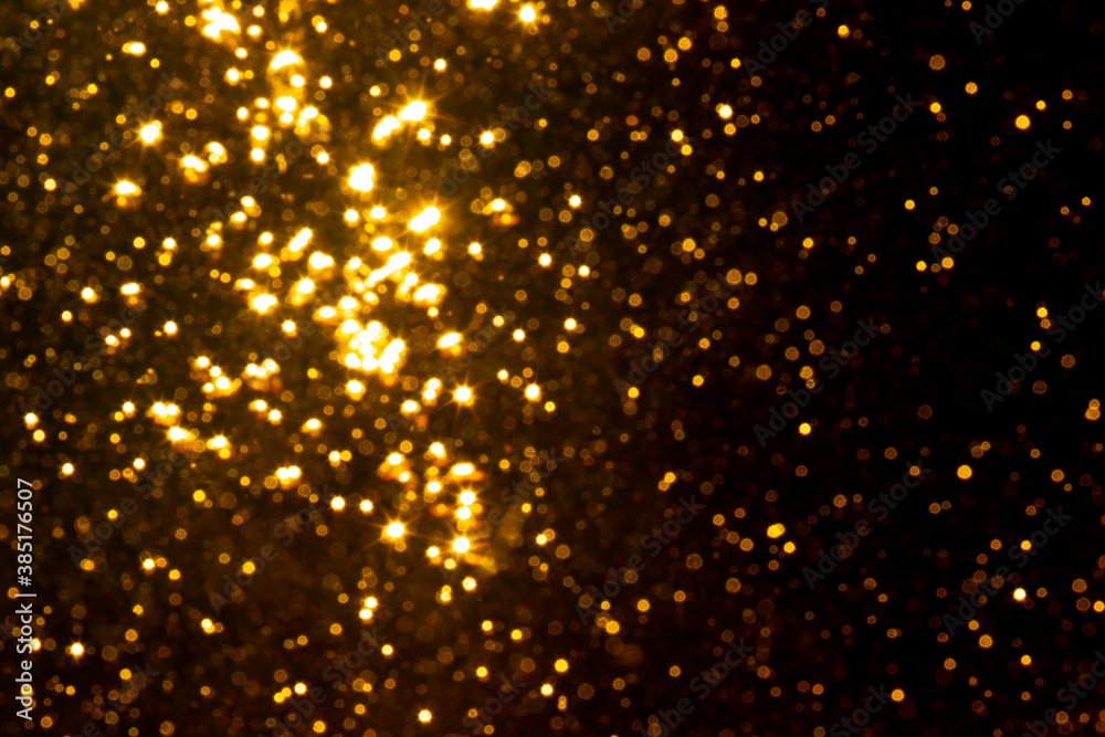 Fototapeta premium Abstract gold bokeh with black background