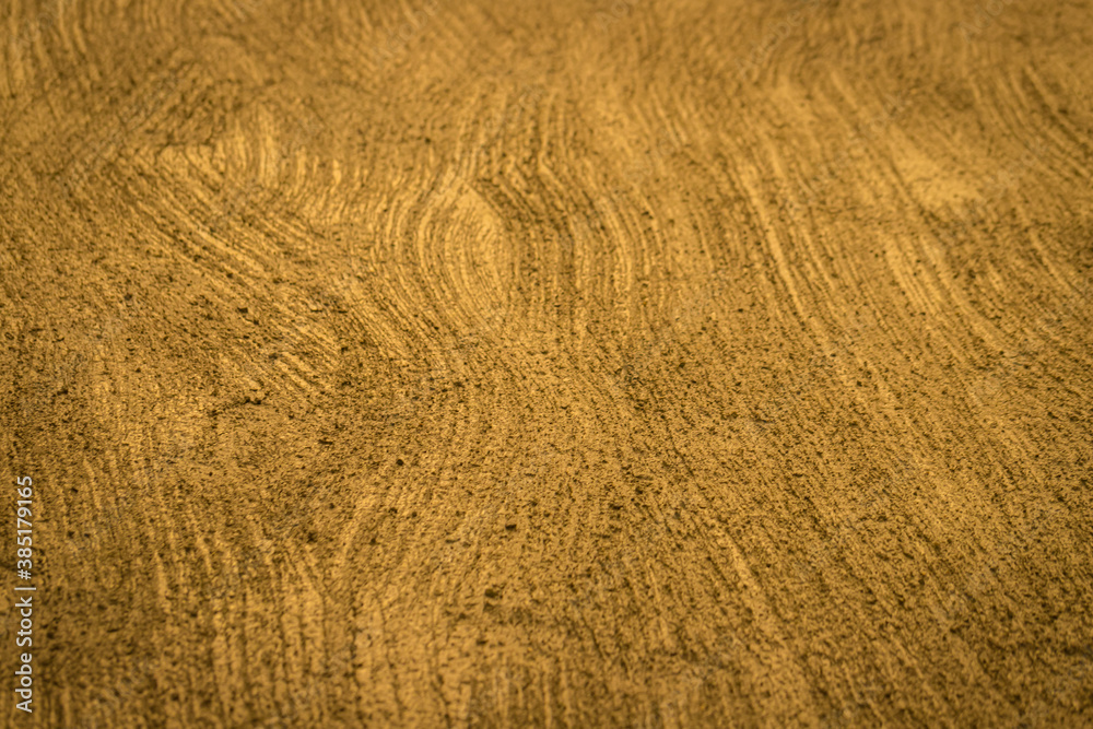 Gold wall treated with textured Rough plaster Gold wall treated with textured Rough plaster