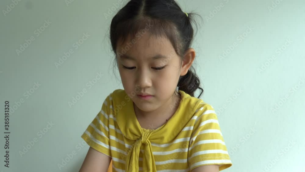 Cute smart primary school child girl learning writing doing math homework sit at home table, adorable pretty little preschool kid studying alone making notes, children elementary education concept Cute smart primary school child girl learning writing doing math homework sit at home table, adorable pretty little preschool kid studying alone making notes, children elementary education concept