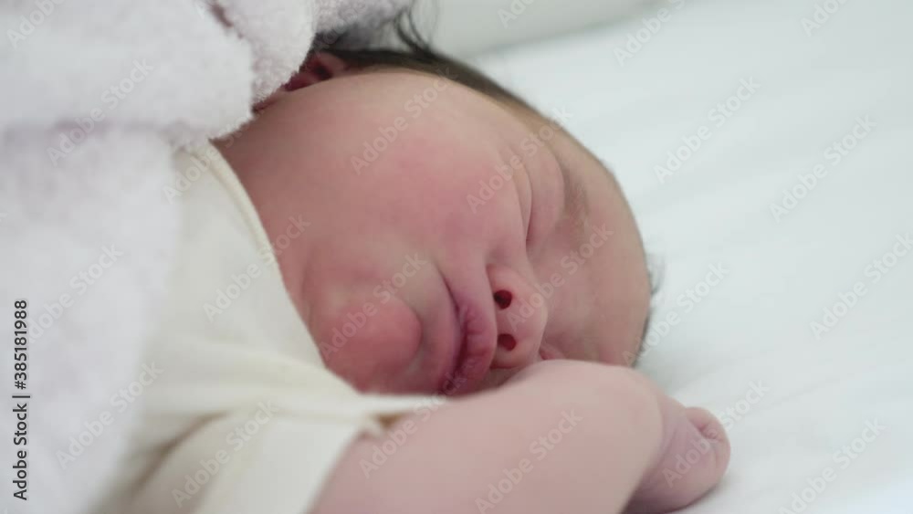 Close up what of a mixed Asian baby as they are in a deep sleep. Close up what of a mixed Asian baby as they are in a deep sleep.
