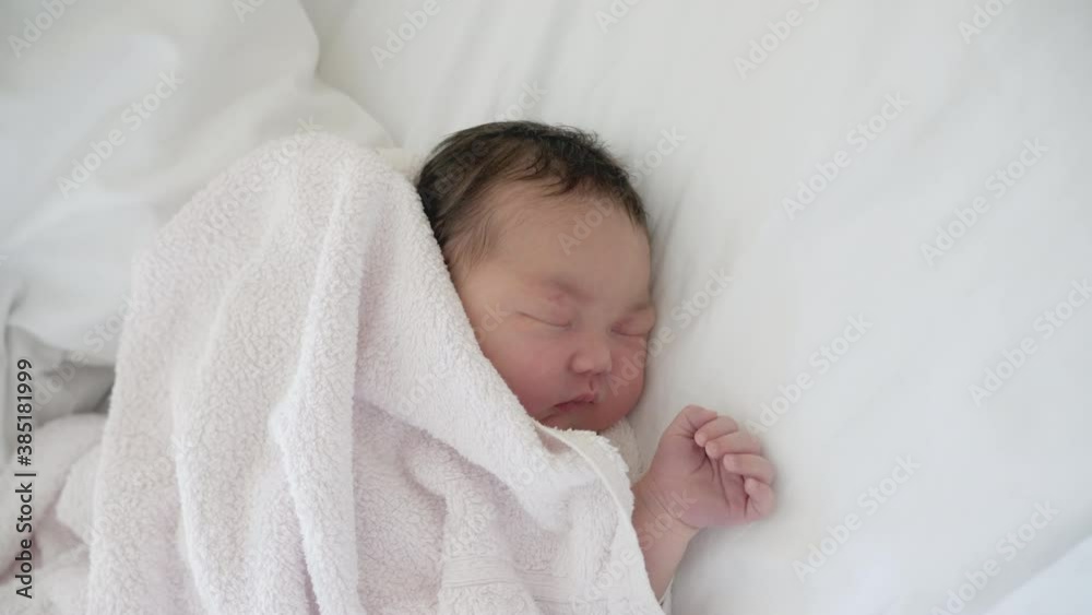 Camera rotates around sleeping newborn mixed asian baby. Camera rotates around sleeping newborn mixed asian baby.