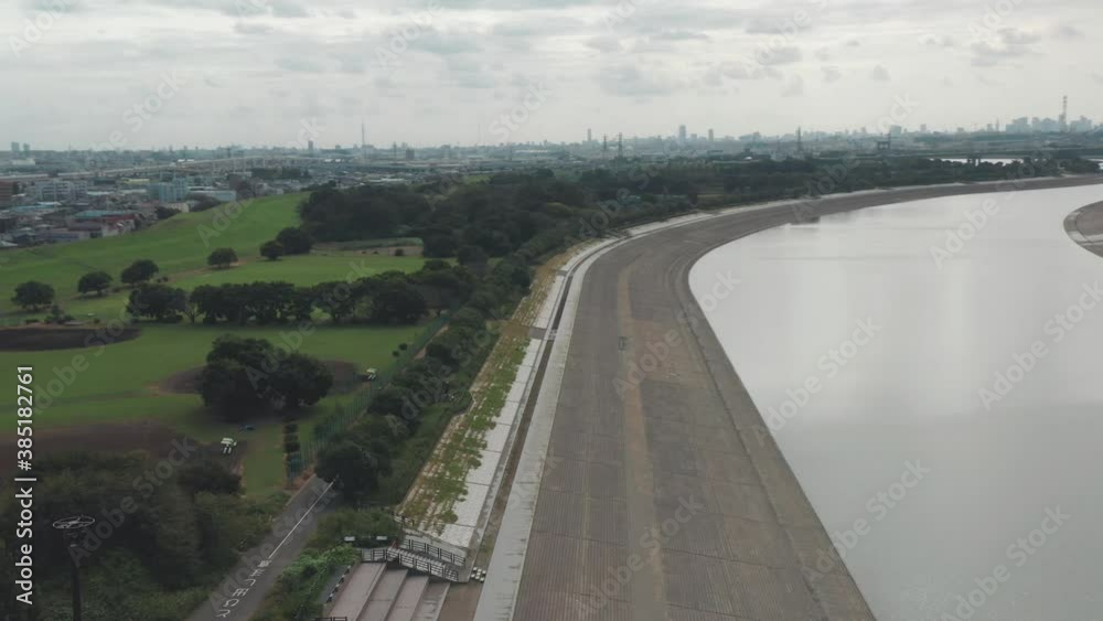 Aerial View Of Flood Control Berm At The Arakawa River In Saitama, Japan - panning drone shot Aerial View Of Flood Control Berm At The Arakawa River In Saitama, Japan - panning drone shot