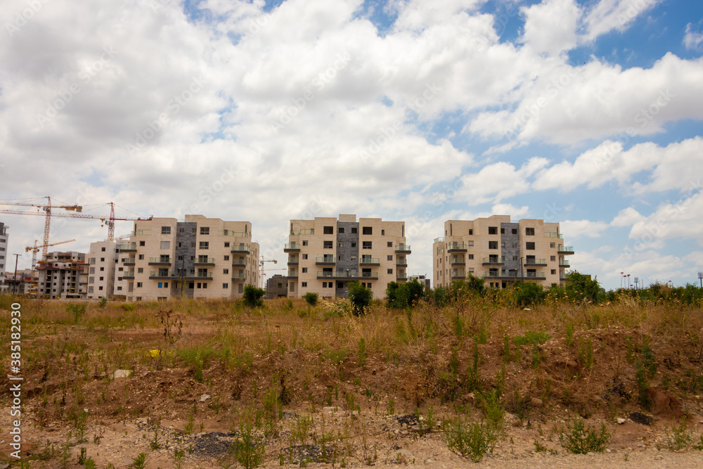 Ganei Ayalon neighborhood at the entrance to Moshav Ahisamakh, new buildings against a background of cloudy skies