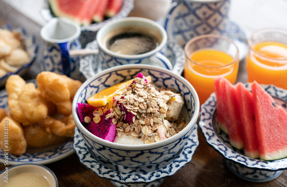 Healthy breakfast snack, granola, muesli with yogurt and tropical fruit in bowl in the morning. Healthy breakfast snack, granola, muesli with yogurt and tropical fruit in bowl in the morning.