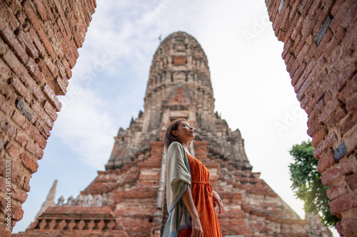 Asian woman travelling at Wat Chaiwatthanaram temple, Ayutthaya,  Thailand.
