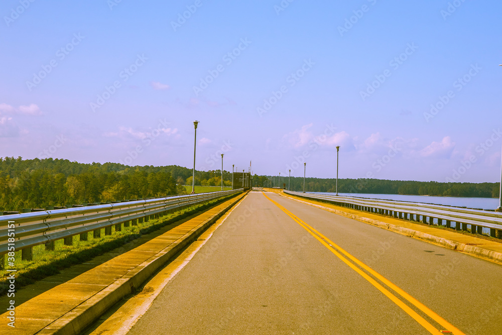 A long empty road by Lake Thurmond