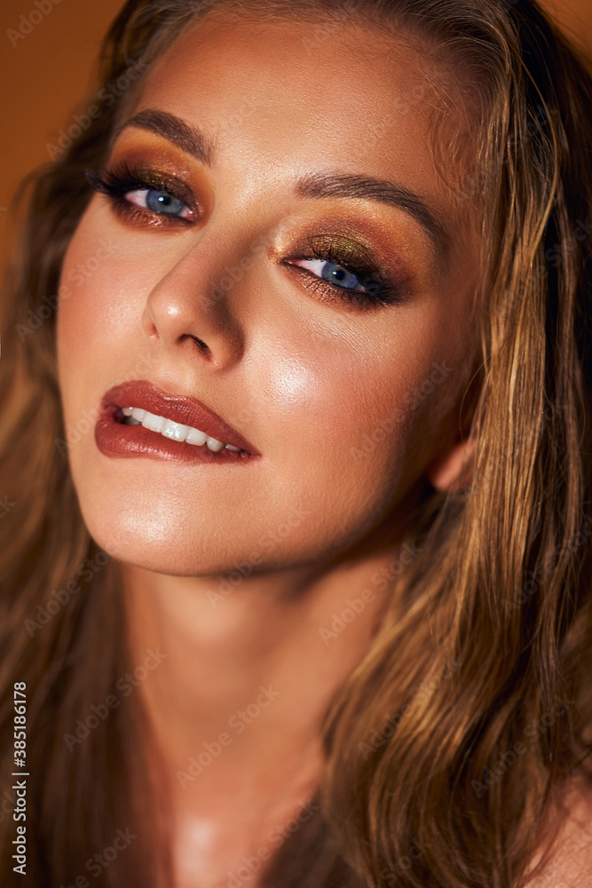 Portrait of a beautiful girl model with makeup. An attractive women of European appearance with blue eyes. Model with beautiful evening make-up