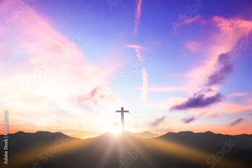 Christian cross concept: Silhouette cross on mountain sunset background