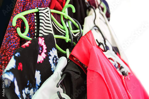 Colorful clothes hanging in disorder