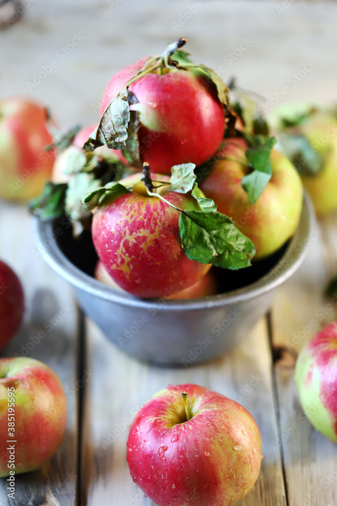 Selective focus. Fresh autumn apples in a bowl on a wooden surface. Harvest apples. Selective focus. Fresh autumn apples in a bowl on a wooden surface. Harvest apples.