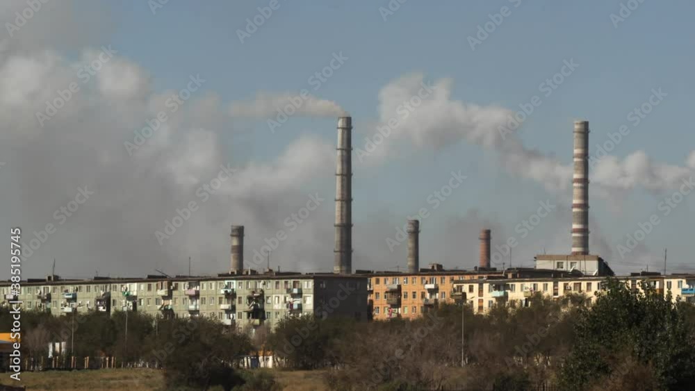 A series of chimneys pumping smoke into the air, further polluting the atmosphere A series of chimneys pumping smoke into the air, further polluting the atmosphere