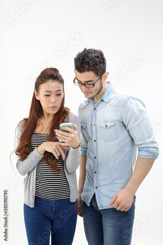 Yong south east Asian middle eastern Caucasian youth man woman in casual look talk discuss at smart phone on white background