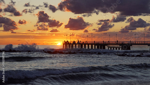 sunset on the sea with a pier