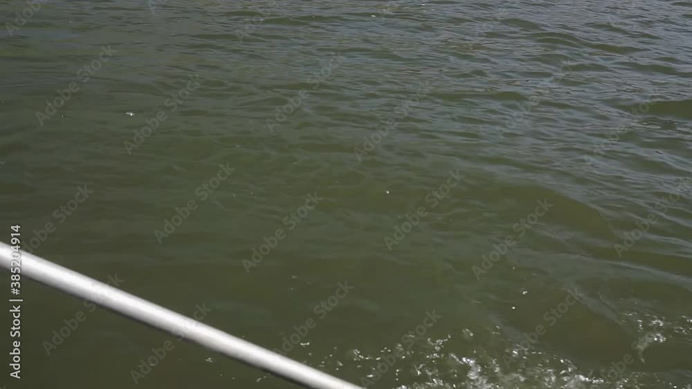 Boating on the big river. One paddle is visible close-up. Clear water. Boating on the big river. One paddle is visible close-up. Clear water.