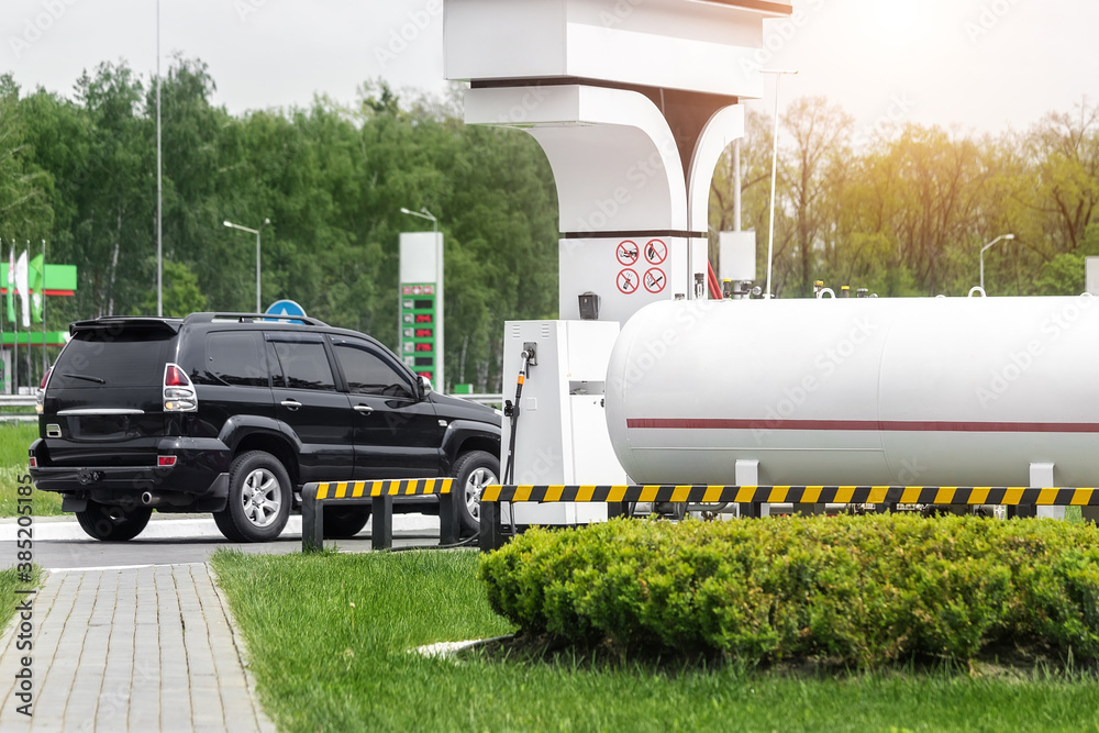 Liquid propane gas station. Black modern SUV car refueling tank with alternative power natural