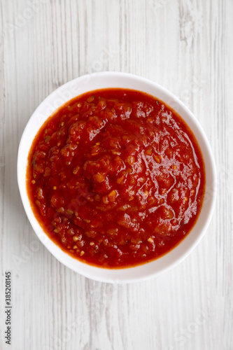 Homemade Tomato Salsa on a white wooden background, top view. Flat lay, overhead, from above.