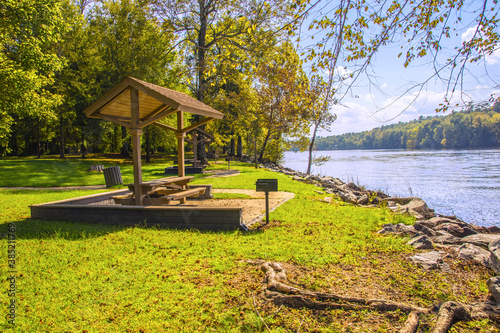 Fototapeta Naklejka Na Ścianę i Meble -  A picnic area in a park with tables and grills