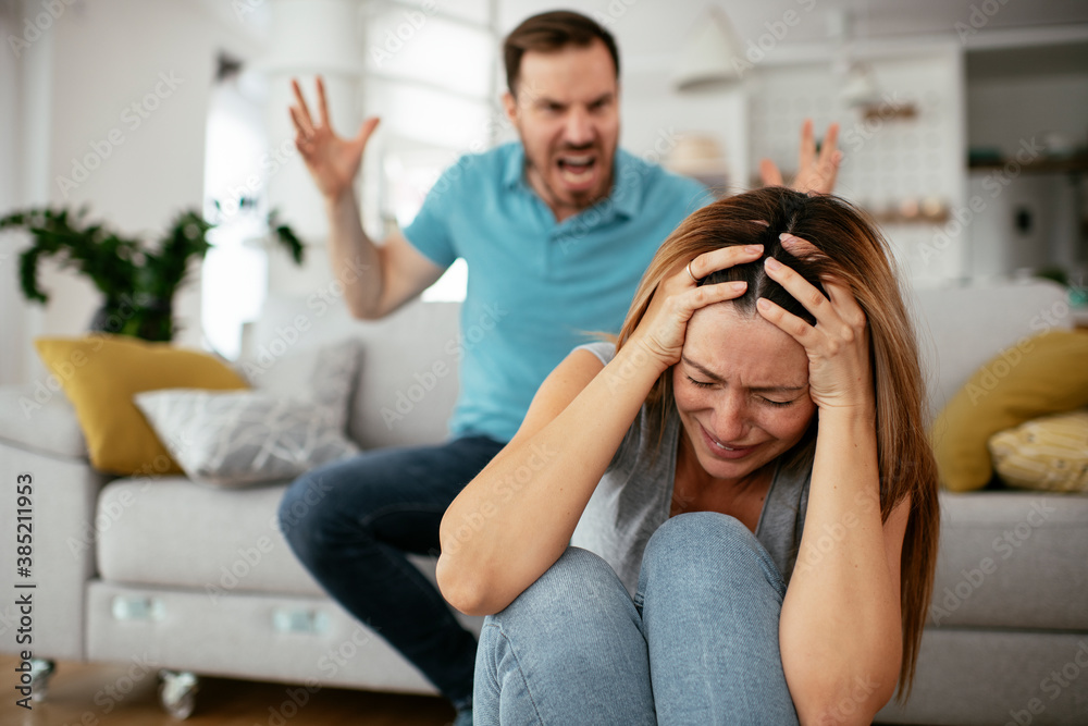Fototapeta premium Violence in family. Husband beating his wife.