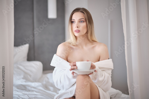 woman drinking morning coffee in her apartment
