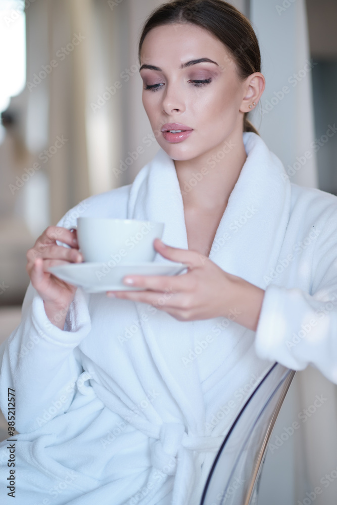 woman drinking morning coffee in her apartment woman drinking morning coffee in her apartment